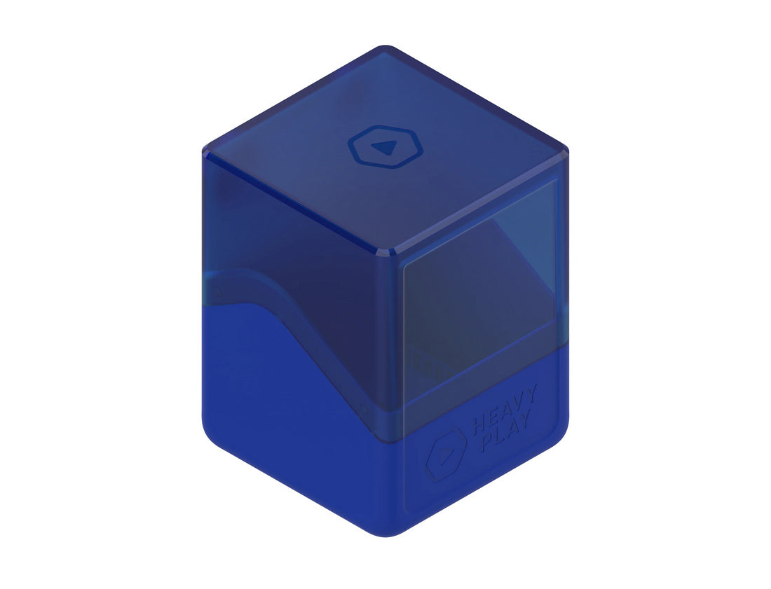 A two-tone blue plastic gaming cube with a translucent dark blue top and opaque royal blue base, marked &quot;HEAVY PLAY&quot; and play symbols