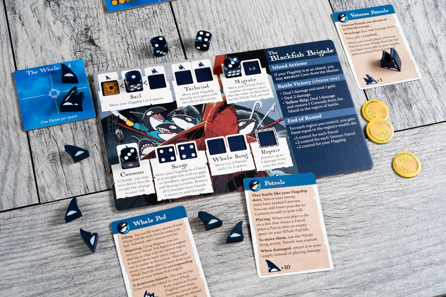 Ahoy: Rivals & Renegades Expansion board game components: Blackfish Brigade player board, black dice, gold coins, and small black orca fin tokens