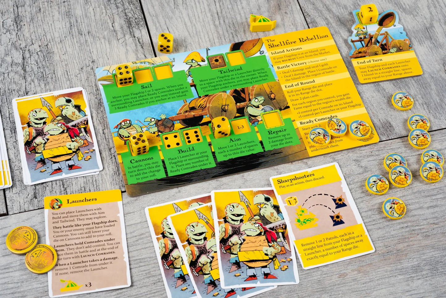 Ahoy: Rivals & Renegades Expansion board game components spread on a wood table, featuring turtle character cards, yellow dice, and tokens