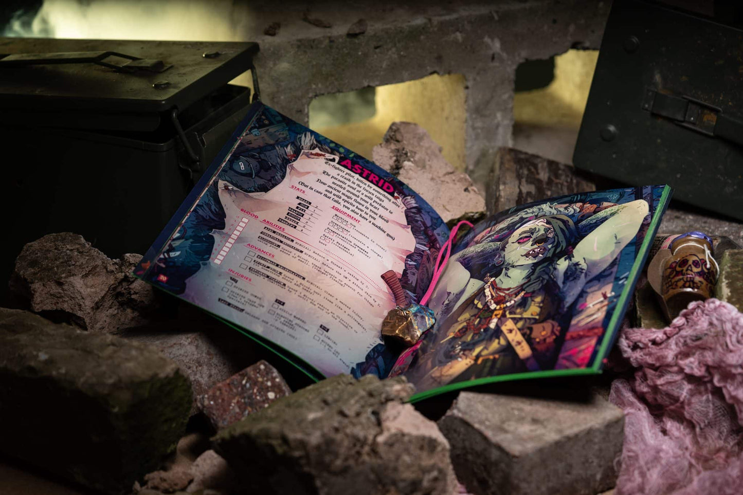 Open RPG character booklet (Astrid) featuring ghoul art and stats, resting on rubble amidst ammo cans
