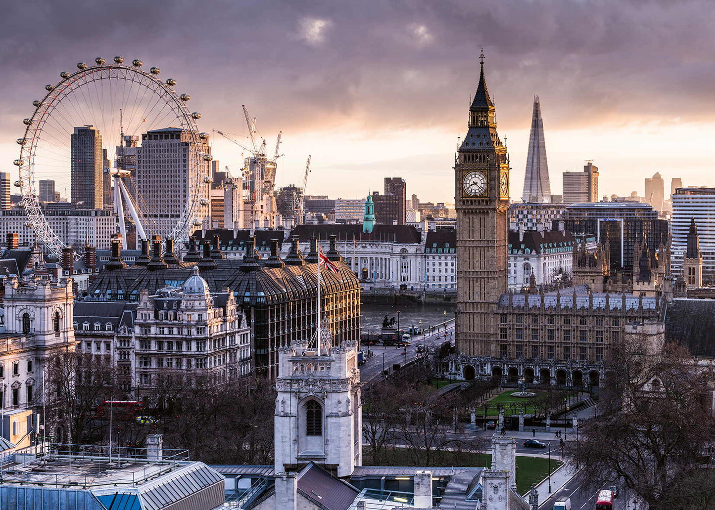 London cityscape with Big Ben, Parliament, London Eye, and The Shard under a dramatic sky