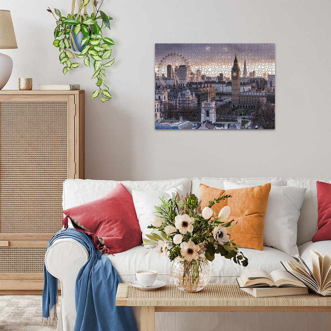 A cozy living room with a completed jigsaw puzzle of the London skyline, including Big Ben, hanging above a white sofa
