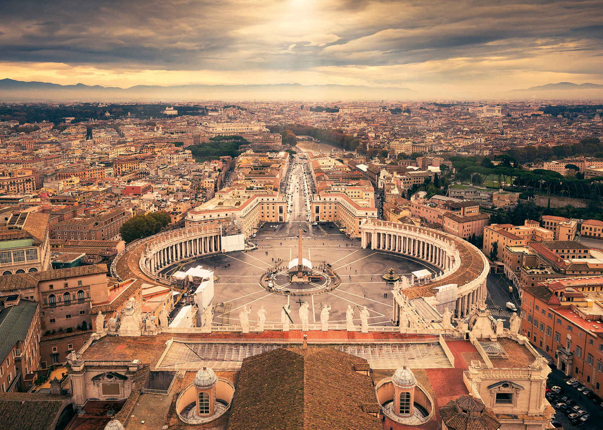 Aerial view of St. Peter&#39;s Square and Vatican City, featuring its grand colonnades and obelisk under a dramatic sky