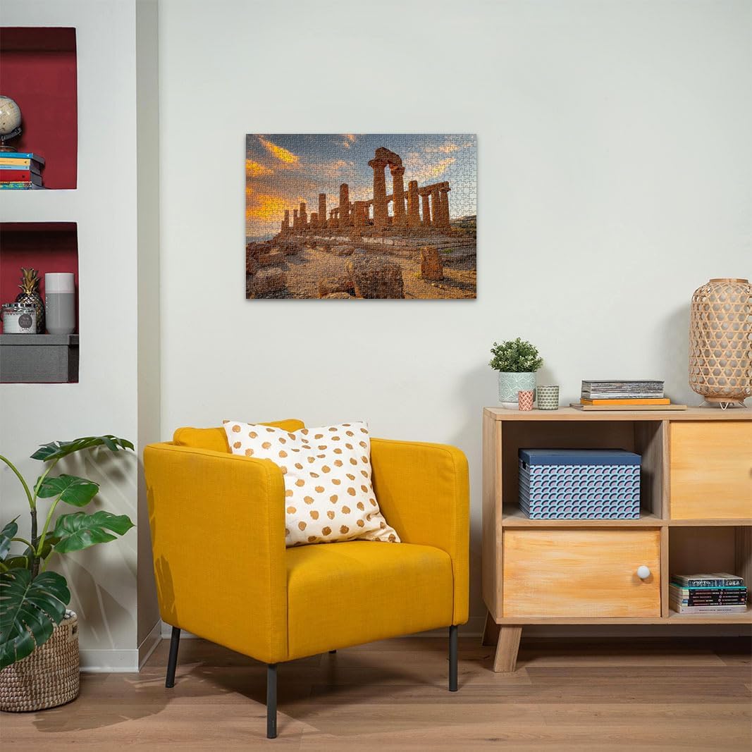 Completed jigsaw puzzle of Ravensburger Valley of the Temples Agrigento Jigsaw puzzle on a wall above a yellow armchair in a living room