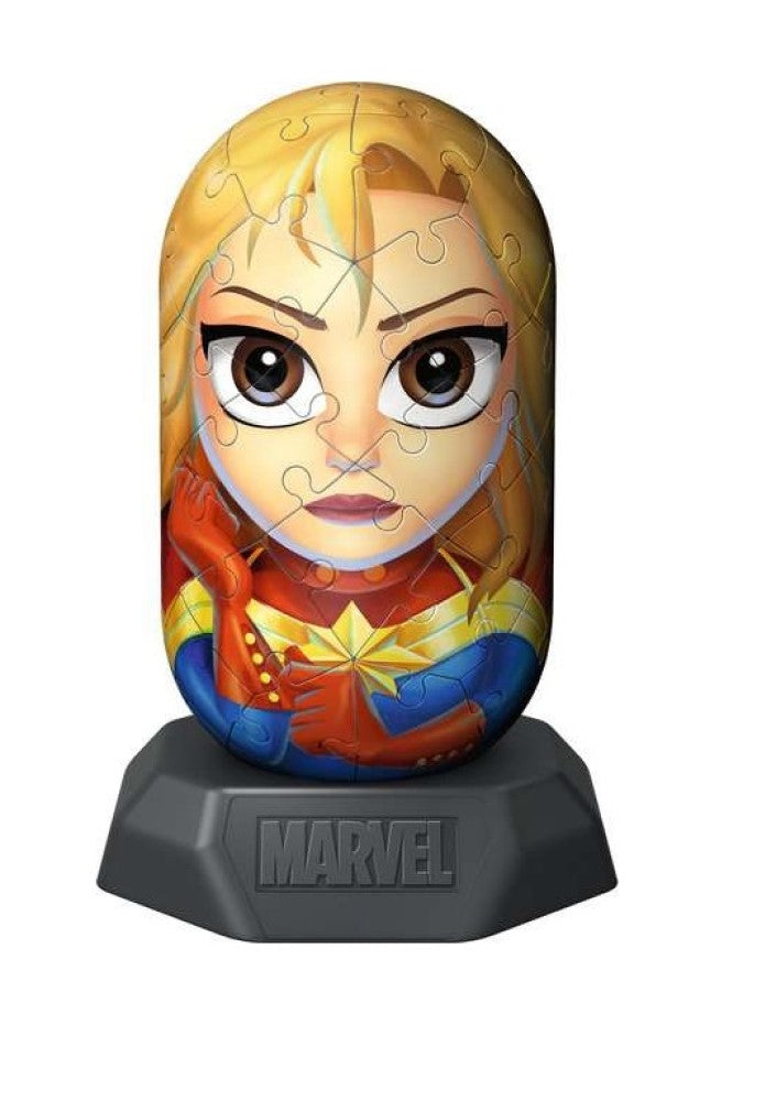 An assembled 3D Captain Marvel puzzle figurine with visible seams, showing her blonde hair and red/blue suit, on a 'MARVEL' base