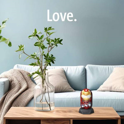 Iron Man-themed item on a wooden coffee table in a living room with a plant, sofa, and 'Love.' on the wall