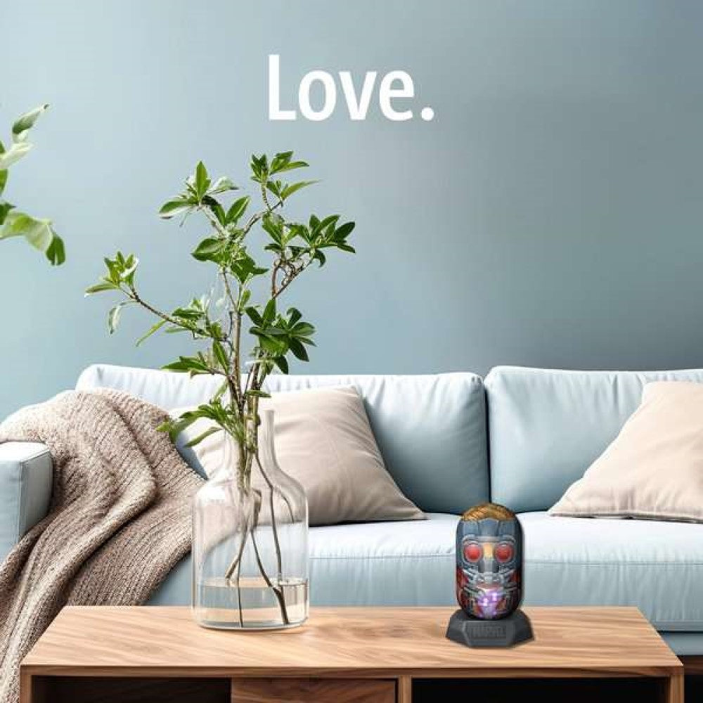 Glowing Star-Lord mask figure on a coffee table in a blue living room. "Love." on wall