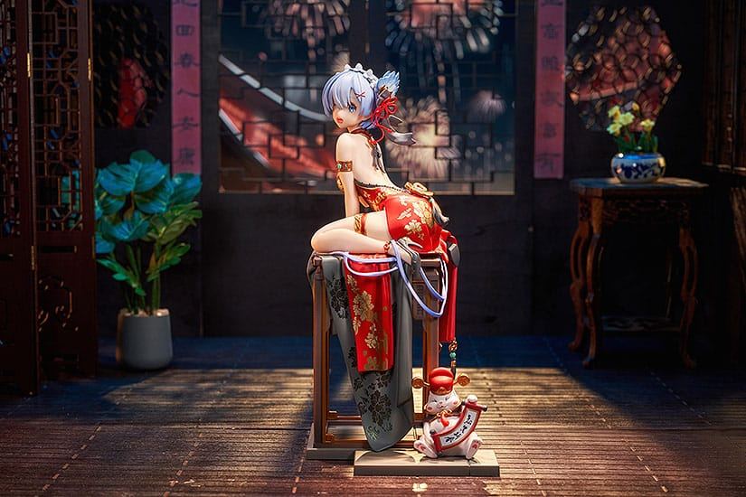 Figurine in red Chinese dress seated with rat figure Traditional room, fireworks view