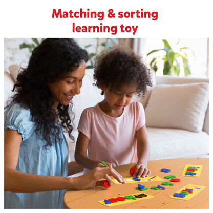 Smiling woman and young girl playing a matching game with brightly colored letter/shape blocks on cards