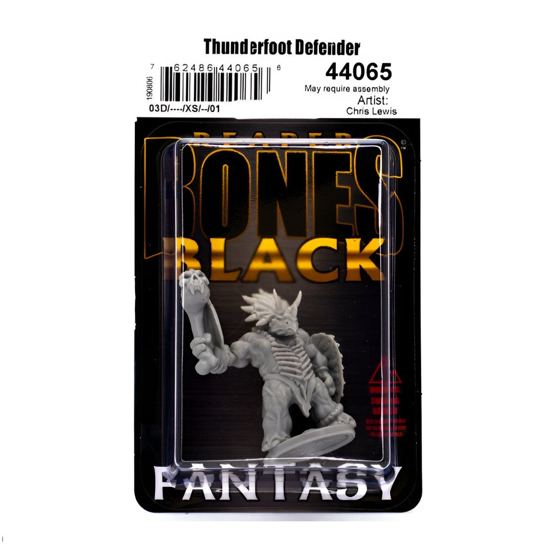 Grey fantasy miniature of a horned Thunderfoot Defender, armed with a club and shield, in a blister pack