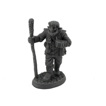 Grey miniature of a bearded gnome holding a carved staff, standing on a stone base