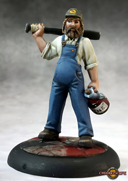 A painted miniature of a rugged, bearded man in overalls and cap, holding a baseball bat and a jug marked "SHINE"