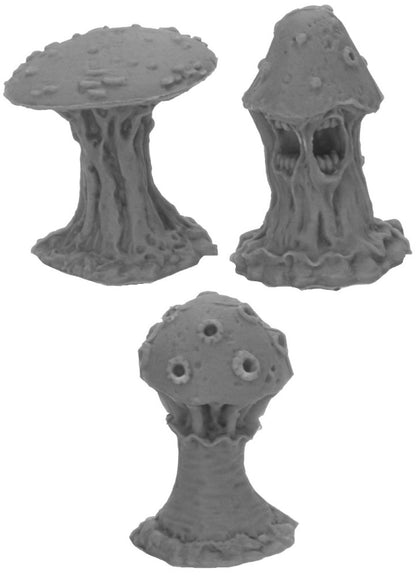 Three gray monstrous mushroom miniatures; one has a gaping, toothed mouth
