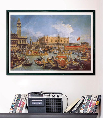 A framed painting of a bustling Venetian canal with many boats and grand buildings, above a retro cassette player and VHS tapes