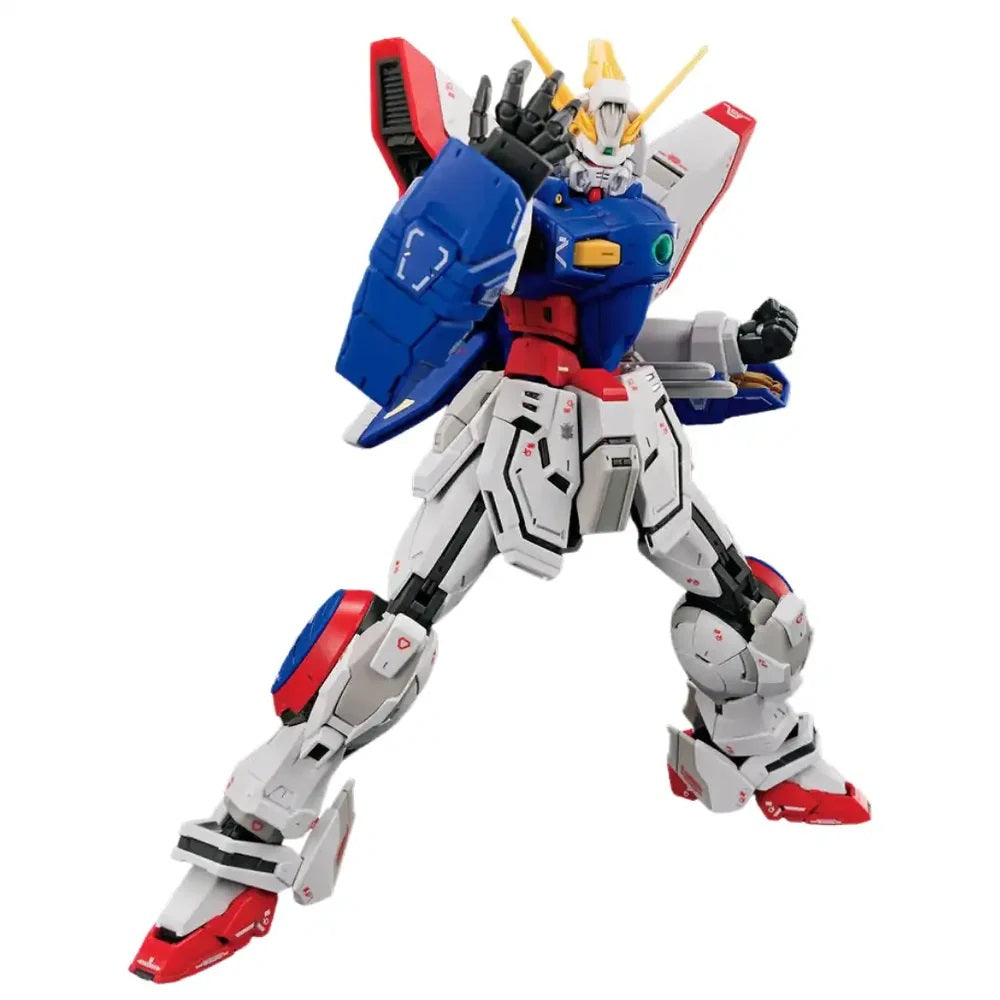 A white, blue, red, and yellow Gundam model in a dynamic action pose, left arm raised and right fist clenched