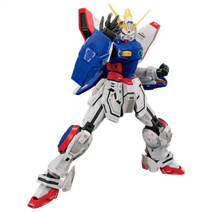 A white, blue, red, and yellow Gundam model in a dynamic action pose, left arm raised and right fist clenched