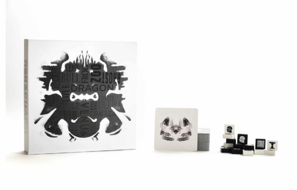 White box and scattered game pieces for the Rorschach test card game