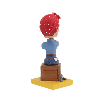 Rosie the Riveter Royal Bobbles bobblehead with red bandana and blue shirt sitting on a crate back view