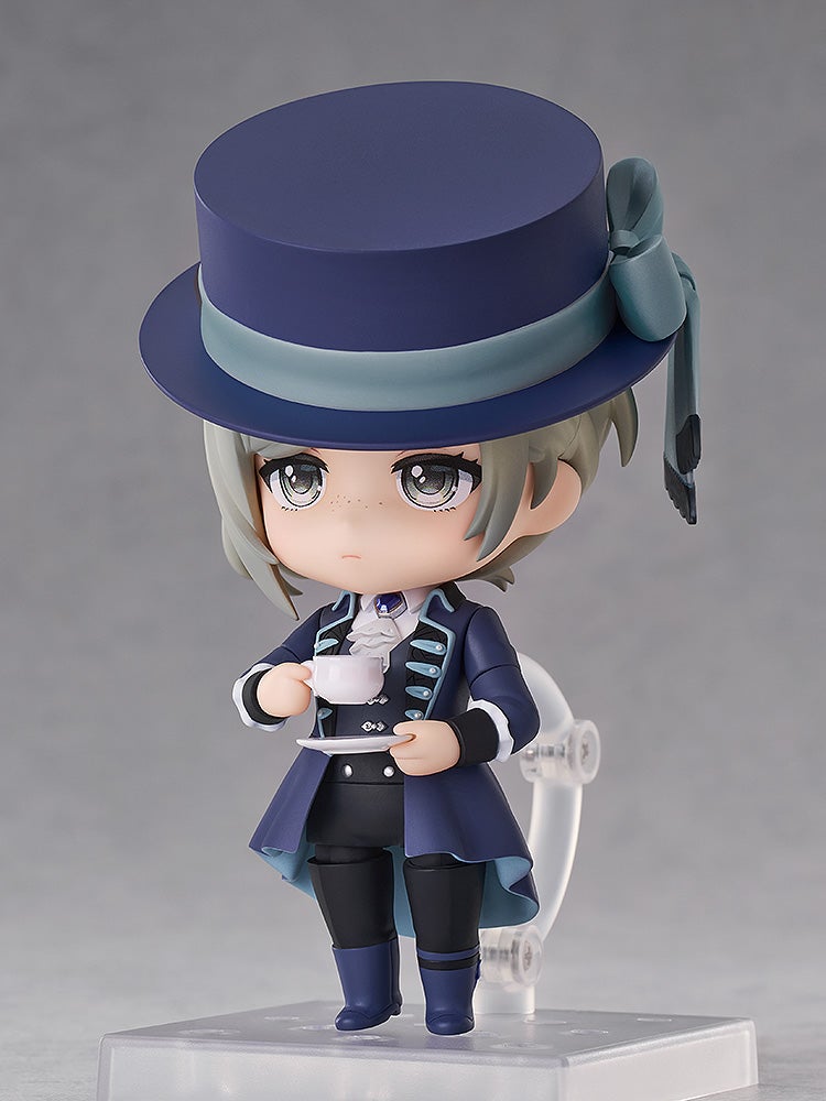 Nendoroid Lilia Vanrouge with dark blue hat and coat holding a teacup and saucer