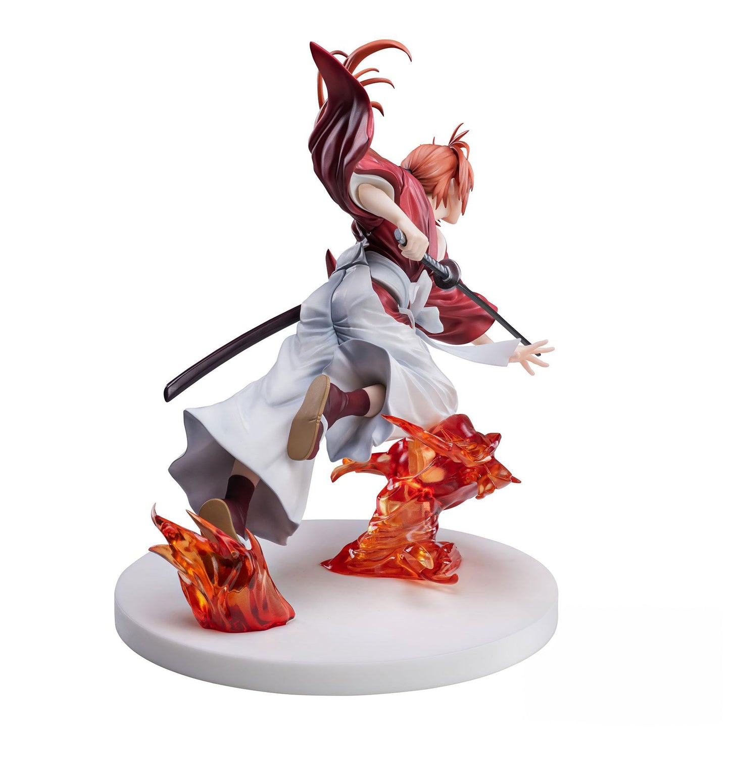 Anime figure of Kenshin Himura in red and white, drawing a katana with fiery orange effects