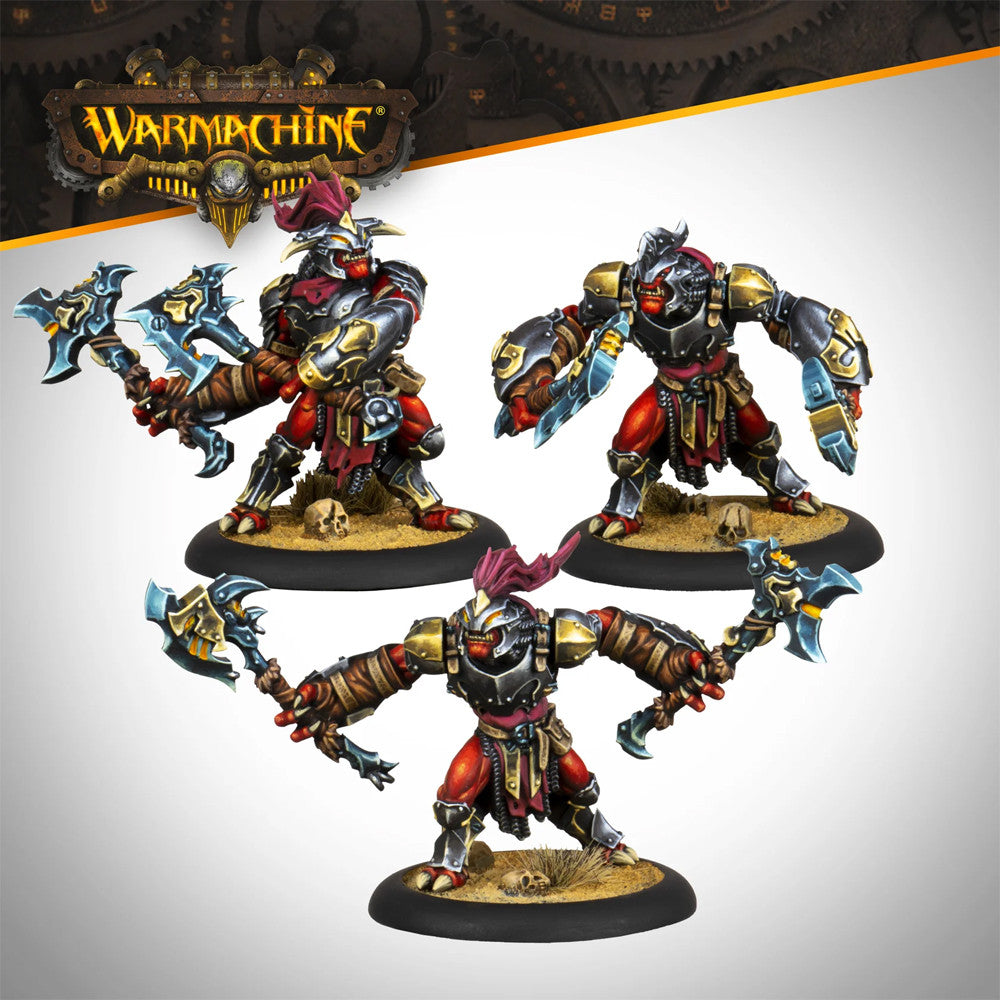 Three red-skinned, armored Warmachine figures with horned helmets, wielding axes and blades, posed on skull-strewn bases