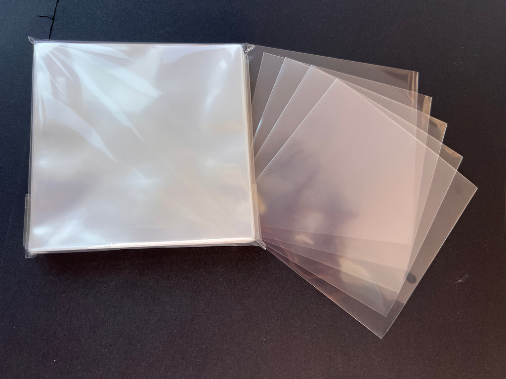 Clear vinyl record sleeves on black background