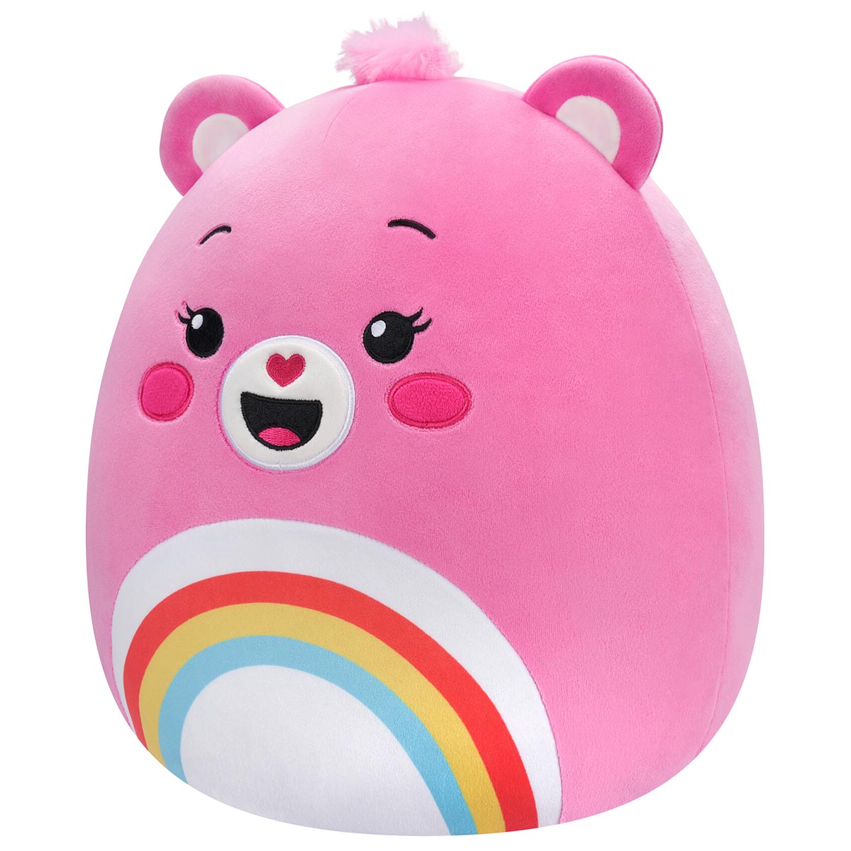 A 10 inch pink Squishmallow Care Bear plush with small ears, a fuzzy pink top knot, and a smiling embroidered face above a vibrant rainbow belly design