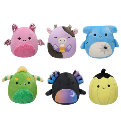Six Halloween Squishmallows are displayed: a pink bat, purple cow, blue shark, green monster, black axolotl, and yellow pumpkin plush toys