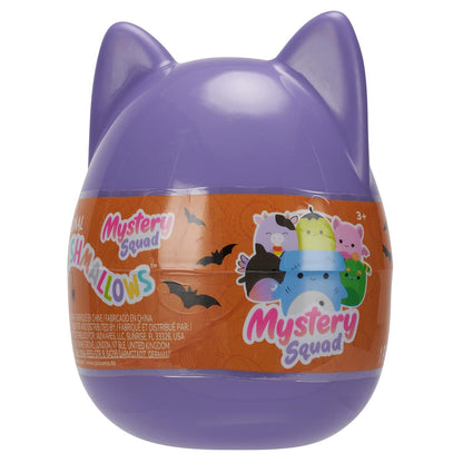 A purple cat-eared Squishmallow mystery capsule with an orange band showing bats and a group of five colorful plush characters