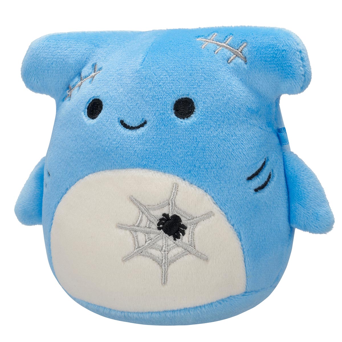 A blue Squishmallow plush toy with a smiling face, grey stitches on its head, and a white belly featuring an embroidered spiderweb and black spider