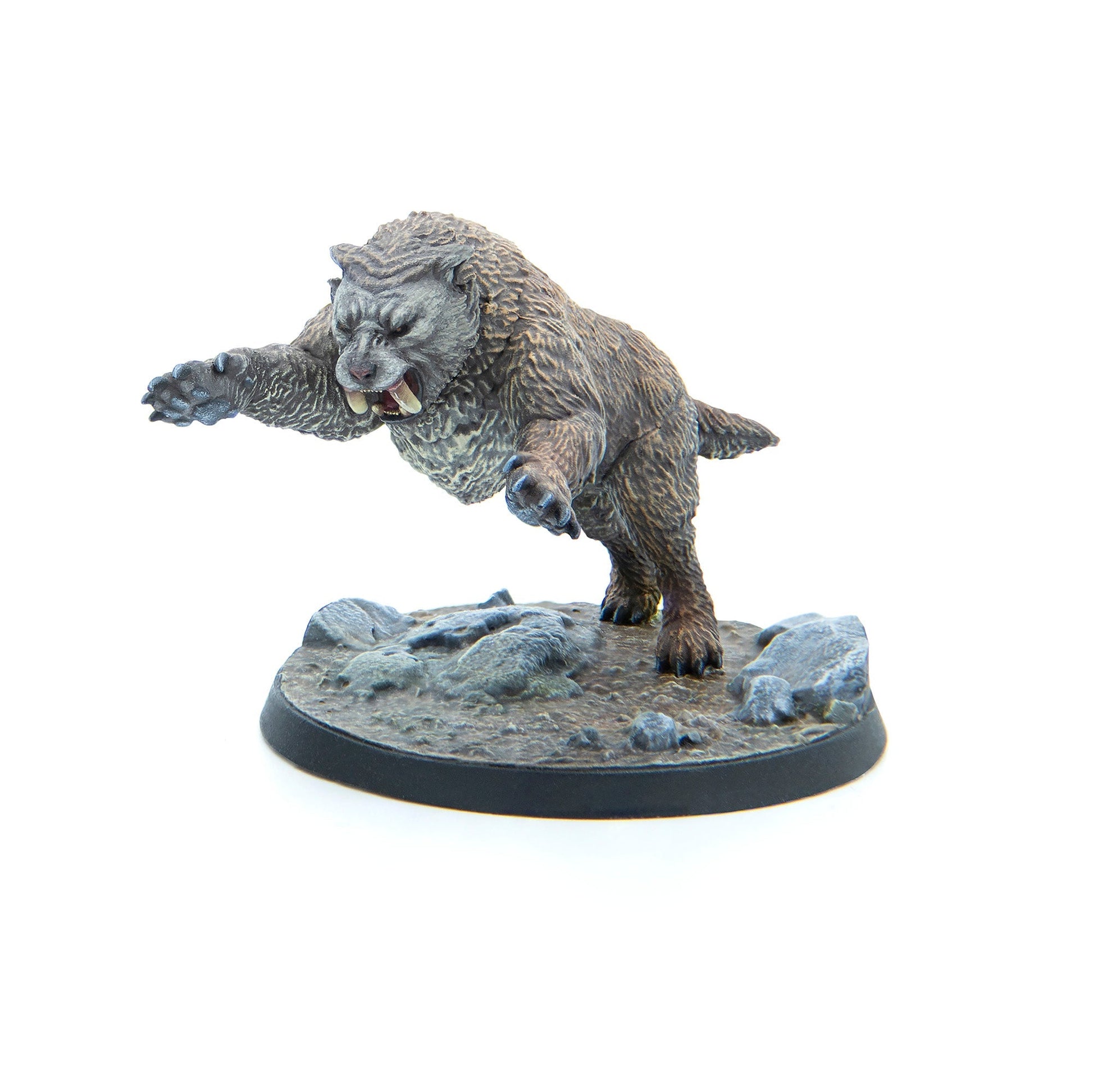 Painted miniature of a greyish-brown, furry beast with fangs, snarling and leaping from a rocky base