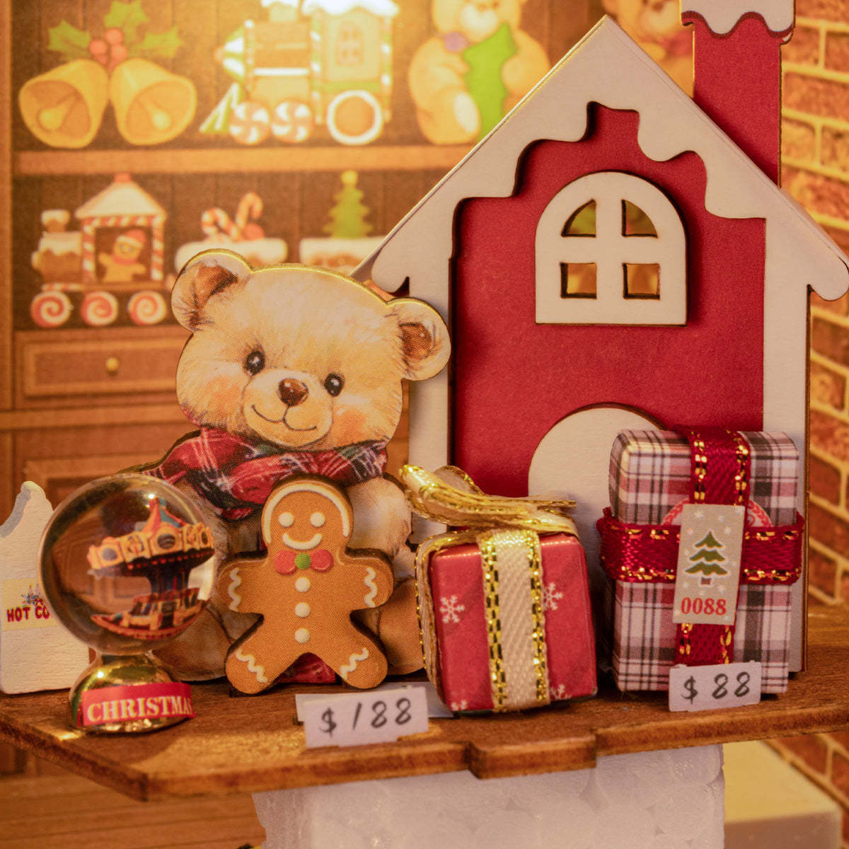 Christmas miniature display with a teddy bear, gingerbread man, red house, and wrapped gifts