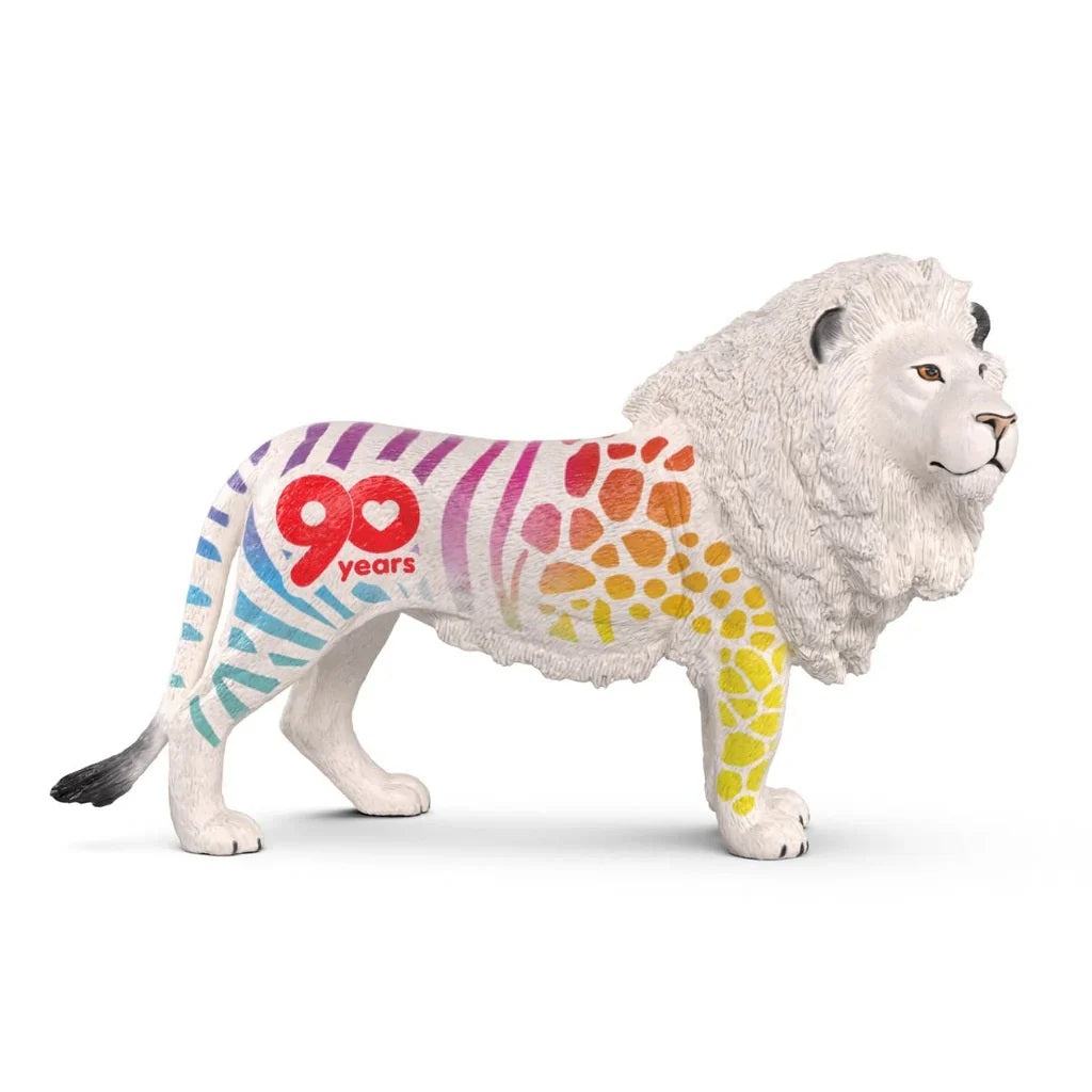 White lion figure decorated with colorful zebra stripes, giraffe spots and a "90 years" logo