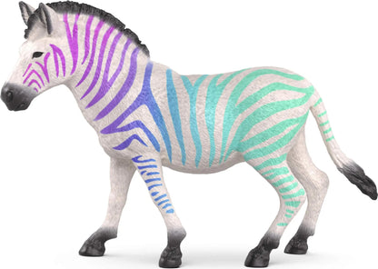 White zebra toy with purple, blue and teal stripes stands on a white background