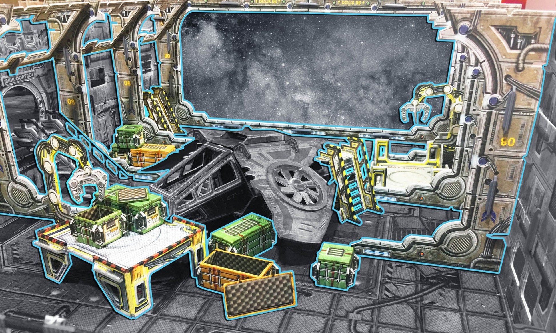 Cardboard space station cargo bay with a space view, mechanical arms, cargo crates, and a damaged ship.