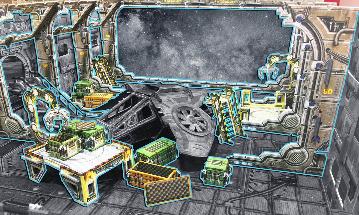 Cardboard space station cargo bay with a space view, mechanical arms, cargo crates, and a damaged ship.