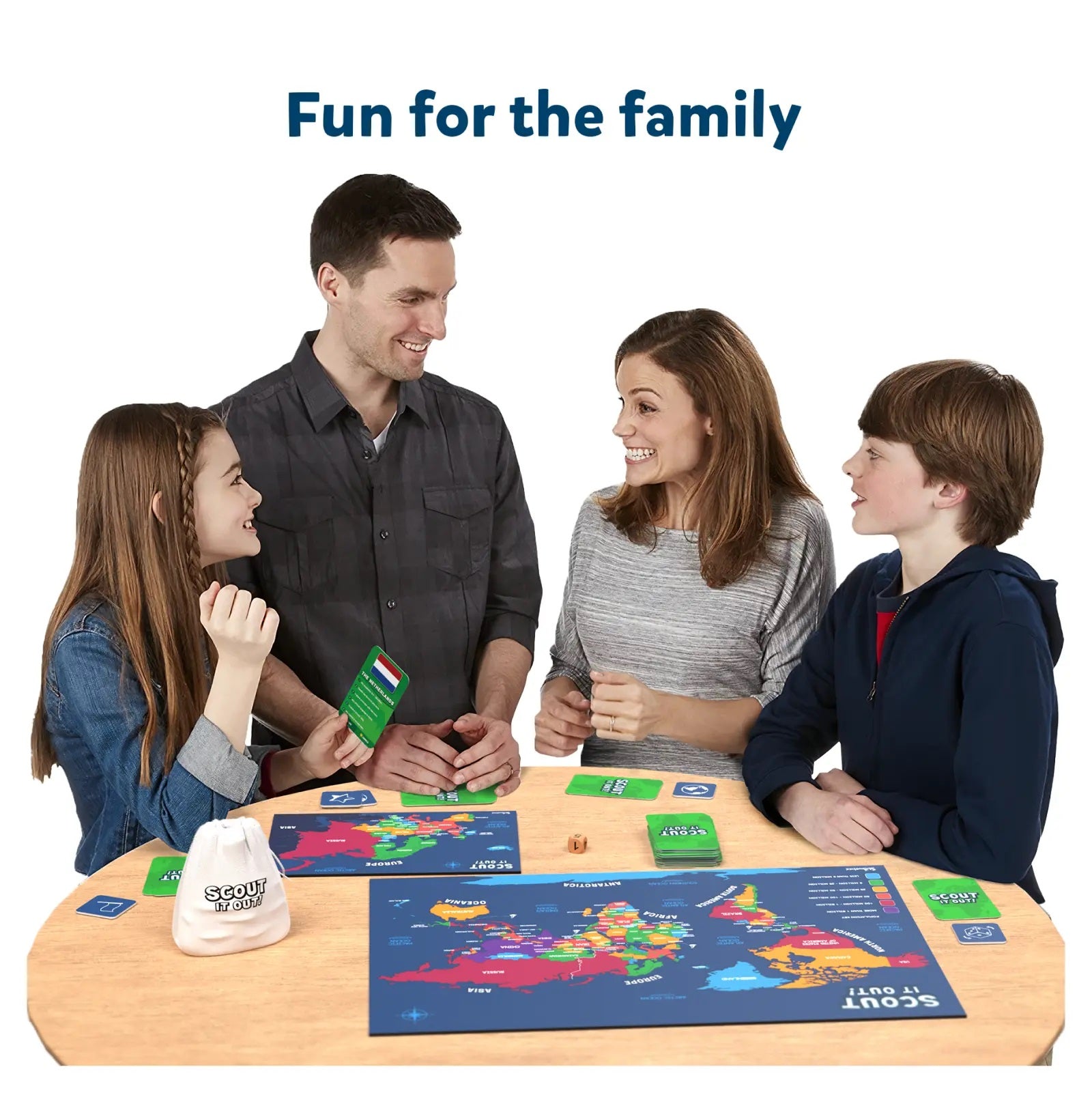 Smiling family of four playing a geography board game with a world map and cards
