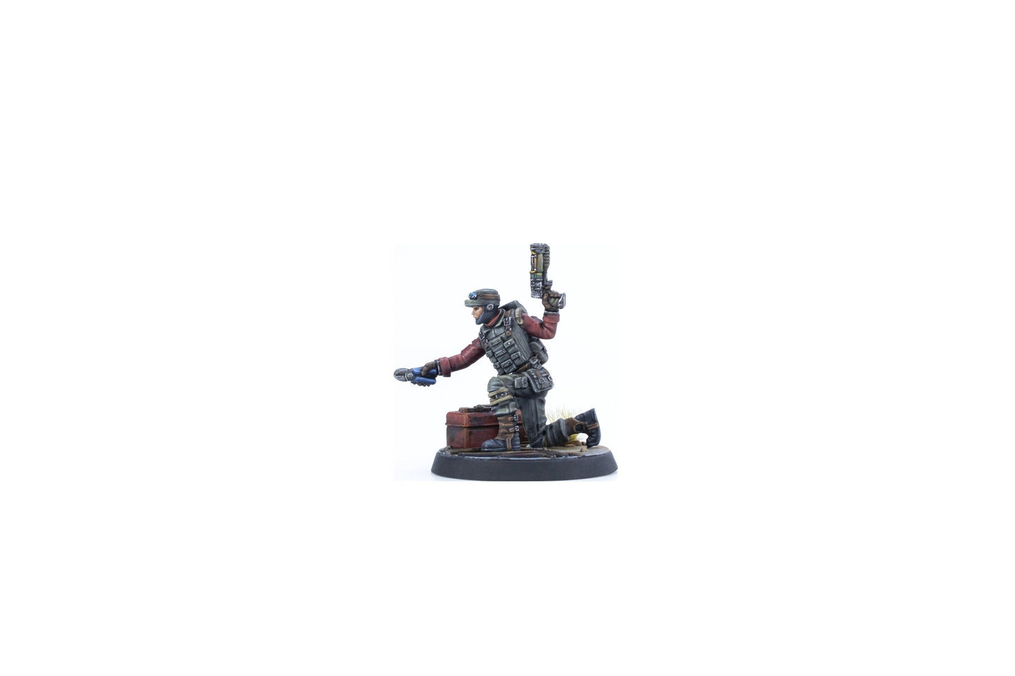 A miniature soldier in tactical gear kneels, holding a pistol up and a blue tool extended