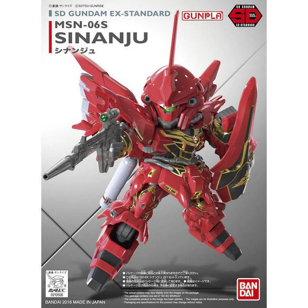 A detailed red and gold SD Gundam EX-Standard Sinanju model holding a rifle and shield