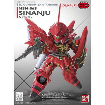 A detailed red and gold SD Gundam EX-Standard Sinanju model holding a rifle and shield