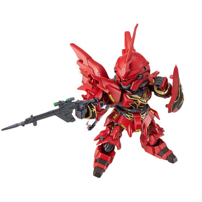 A red SD Gundam Sinanju figure with gold details, holding a rifle and shield