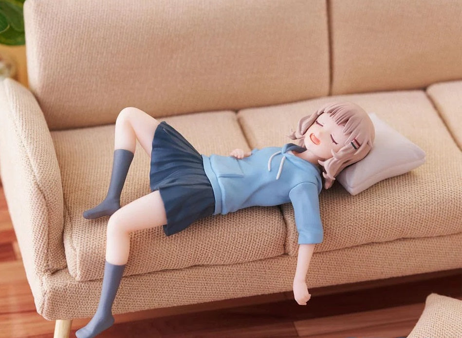 Side angle of figure highlighting seated posture and expression