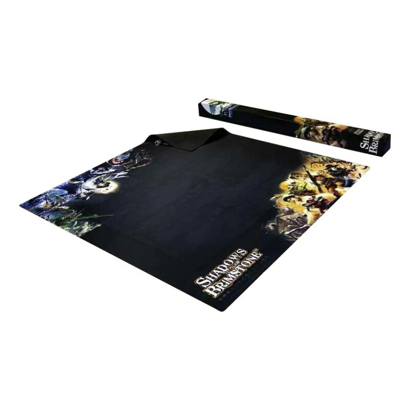 A laid out black Shadows of Brimstone board game playmat with vibrant fantasy art borders, beside its rolled tube.