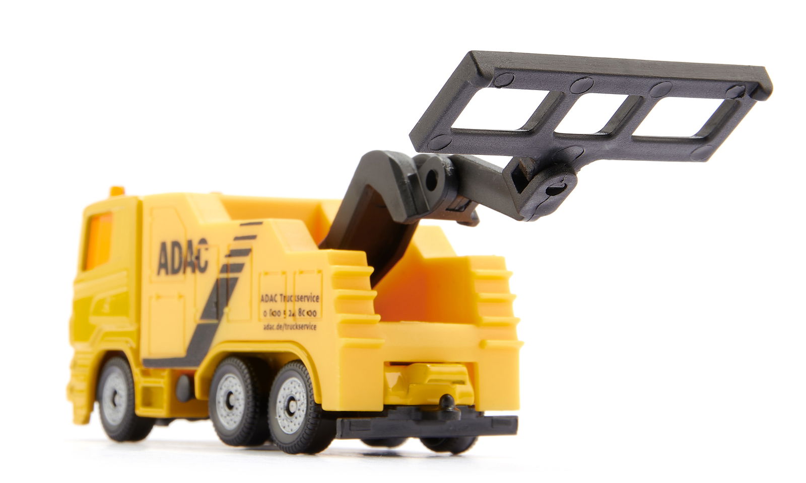 A yellow ADAC toy tow truck with a black lifting arm extended upwards