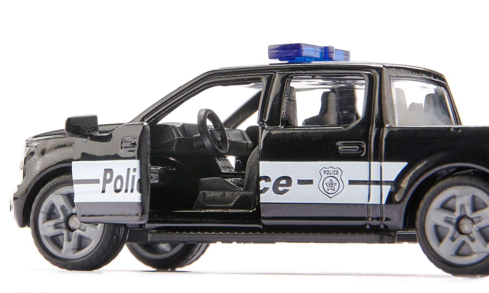 Close-up of a black die-cast Siku Ford F-150 US police truck model with the driver's side door open