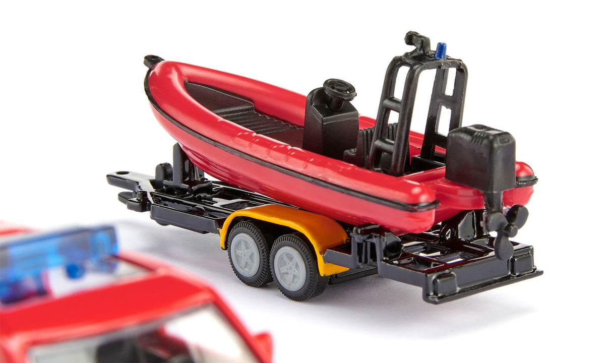 Red toy rescue boat on a trailer, with a partial red toy police car in the foreground