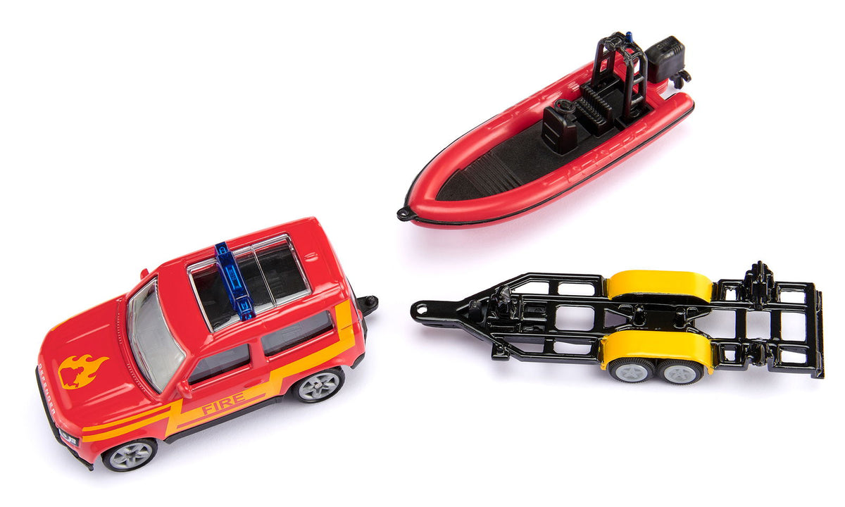 A set of toy fire rescue vehicles: a red Land Rover Defender, a red inflatable boat, and a black boat trailer, on white
