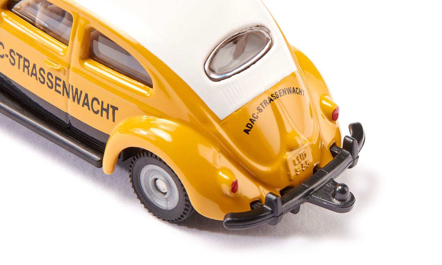 Close-up rear view of a yellow and white VW Beetle model car marked "ADAC-Strassenwacht"