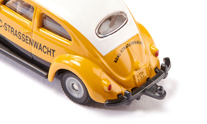 Close-up rear view of a yellow and white VW Beetle model car marked "ADAC-Strassenwacht"
