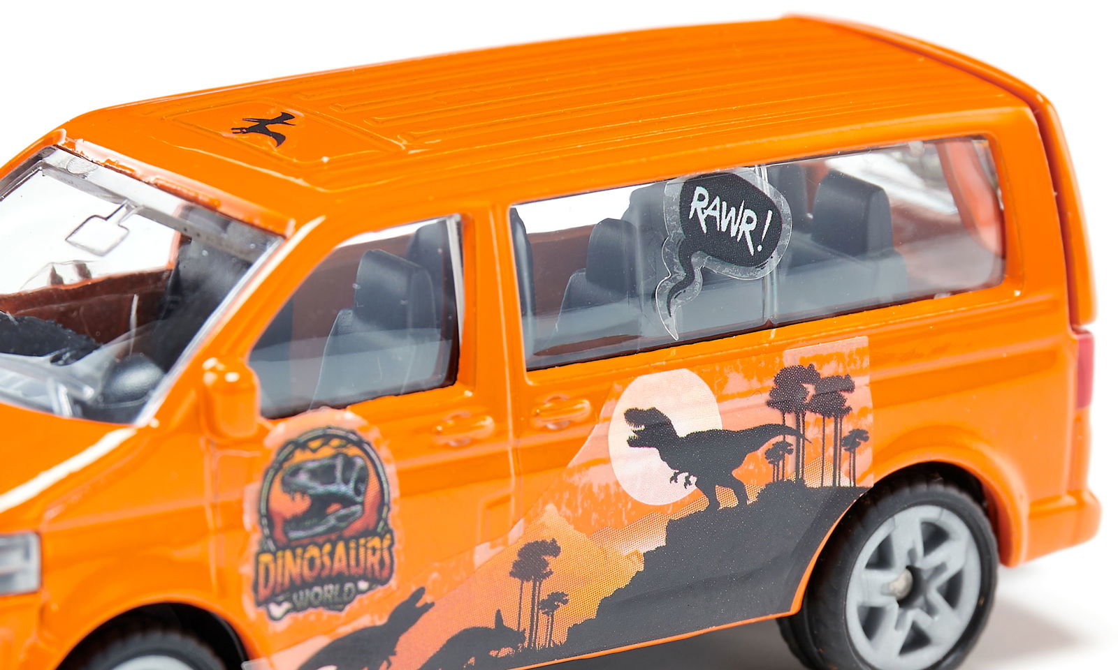 Close-up of an orange VW Multivan toy themed with dinosaurs, featuring a "RAWK!" sticker and "DINOSAURS WORLD" logo